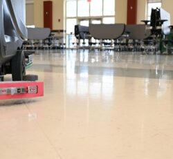 Auto,scrubber,on,a,floor,in,a,school,cafeteria.,automated